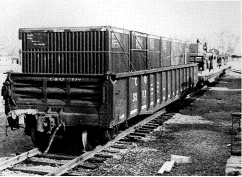 Black and white photo of Transporter Containers being moved by rail. 